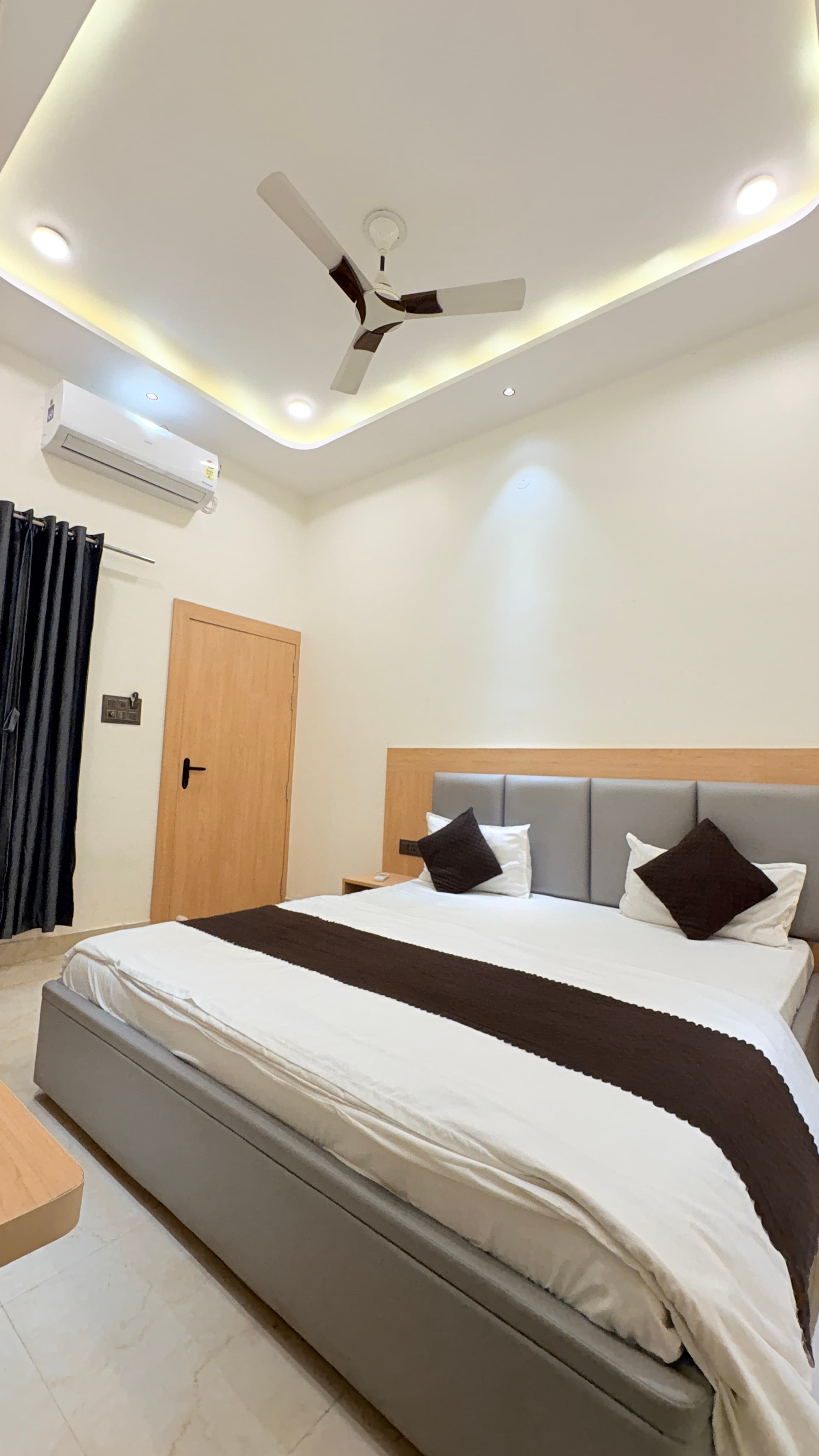 Quiet double room at Kailas Residency with warm recessed lighting