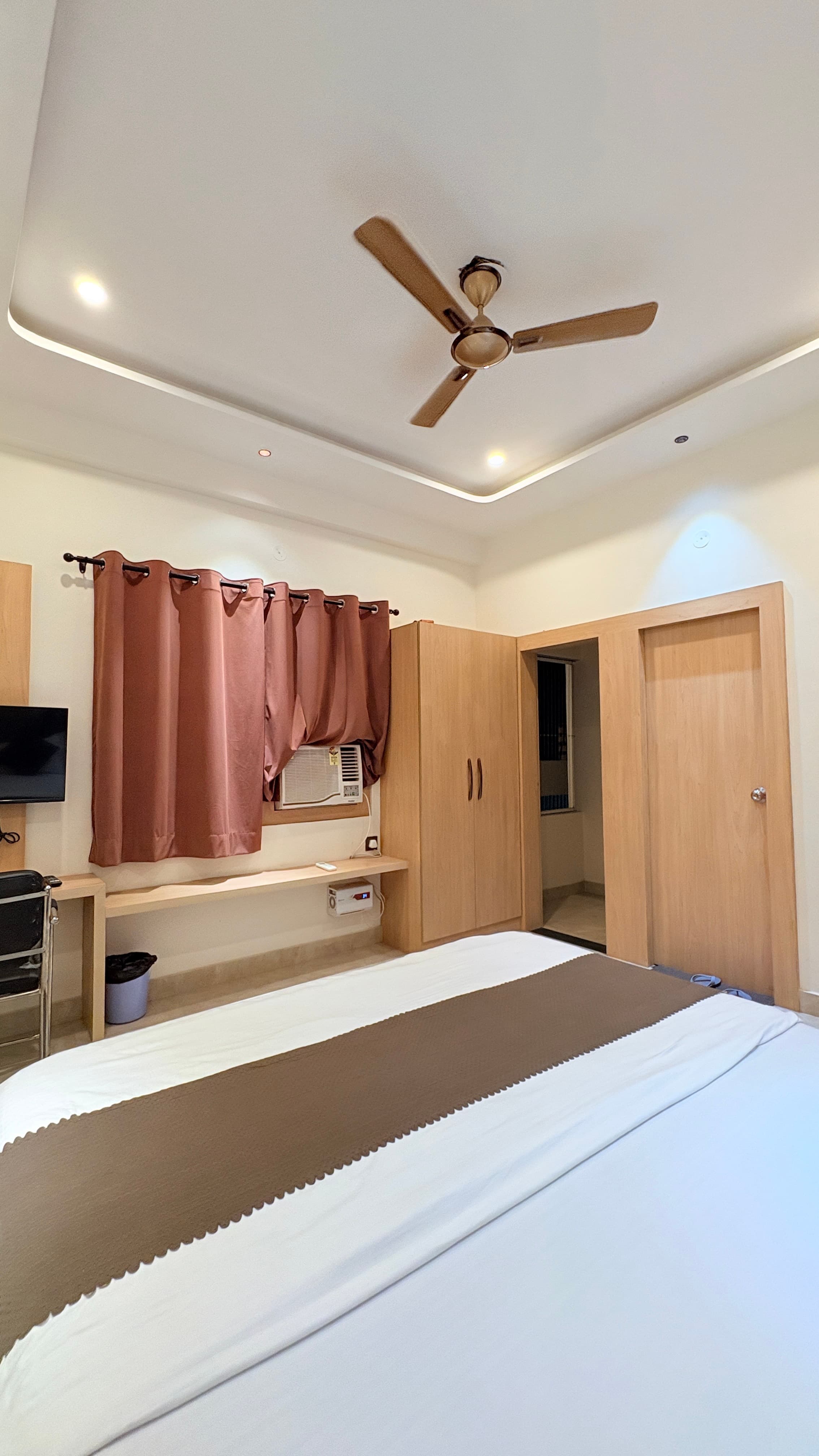 Window desk, wardrobe, and double bed in the premium room